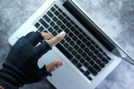 hacker hand pointing finger on laptop screen .の写真素材