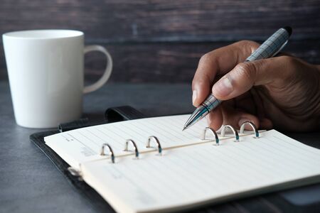 close up of person hand writing on notepad.の写真素材