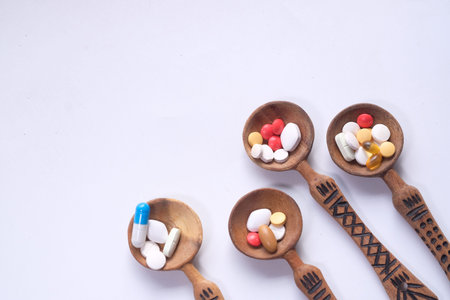 Top view of colorful pills on spoon with copy space