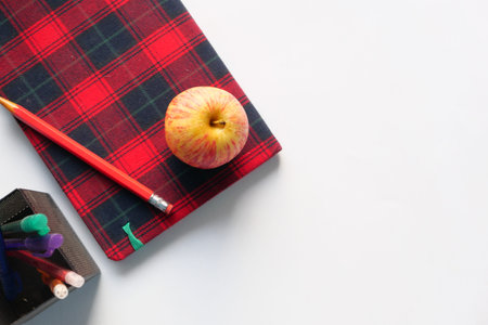 Top view of apple and notepad on white background.の写真素材