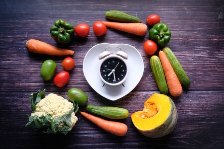 Food clock and fresh vegetable on table.の写真素材