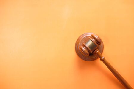 top view of gavel on orange background with copy spaceの写真素材