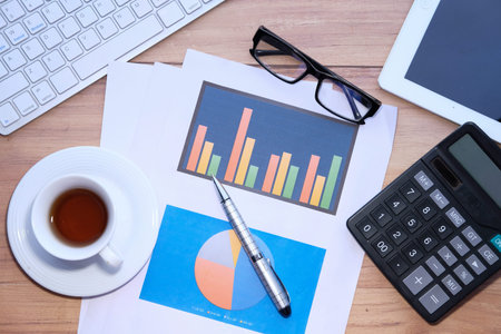 Top view of financial chart and pens on table