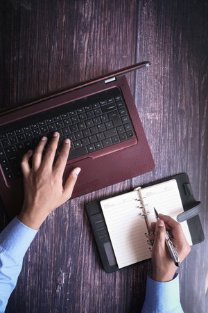 Top view of man hand typing on laptop