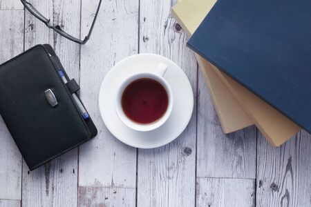 Top view of tea and stack of book on gray background.の写真素材