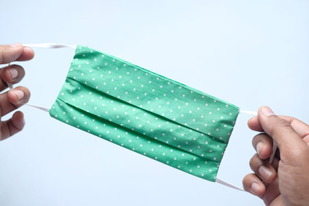 hand holding Face Mask, the concept of corona virusの写真素材