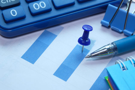 Close up of bar charts and calculator on table