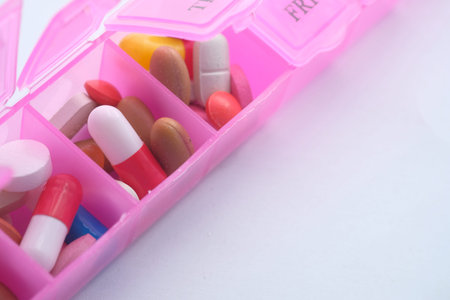 Top view of colorful pills in a pill box