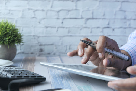 young man working on digital tablet at office desk