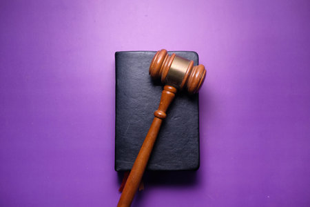 Close up of gavel and book on purple backgroundの写真素材