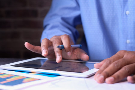 young man working on digital tablet at office desk