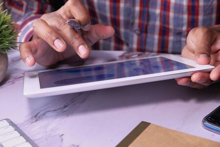 close up of man hand working on digital tabletの写真素材