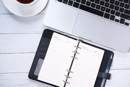 high angle view of open notepad and calculator on tableの写真素材