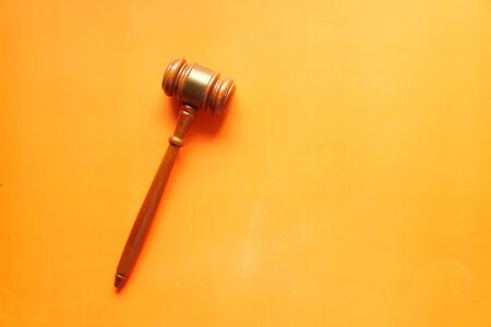 Top view of gavel on orange backgroundの写真素材