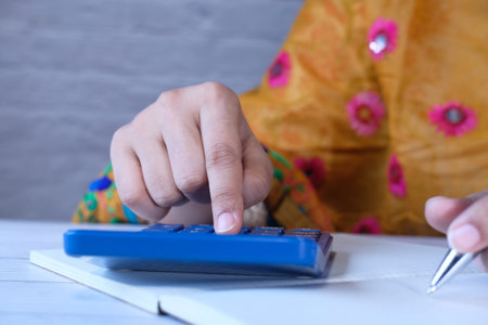 close up of women hand using calculator.の写真素材
