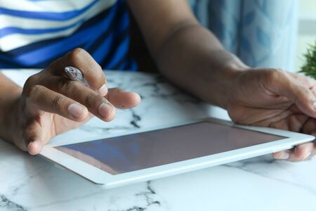 close up of man hand working on digital tablet at homeの写真素材
