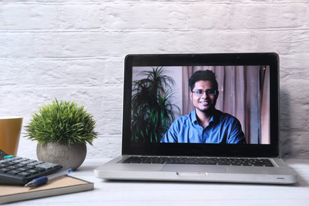 Businessman In a video conference display on laptop screenの写真素材