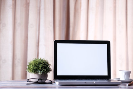 laptop with white screen on office table