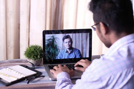 Back view of business man in video conference discussing strategyの写真素材