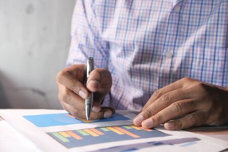 businessman analyzing financial data at office deskの写真素材