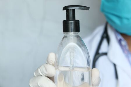 Doctor holding hand sanitizer with copy space .の写真素材