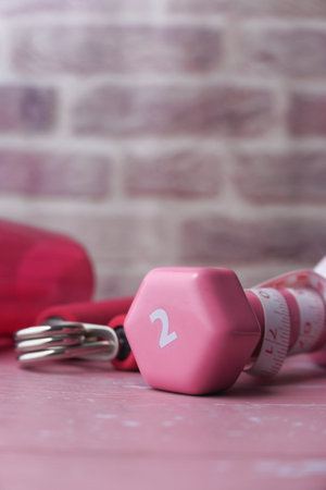 Close up of dumbbell, shoe and water bottle on tableの写真素材
