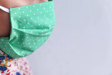 Side view of asian woman wearing flu mask with copy space .の写真素材