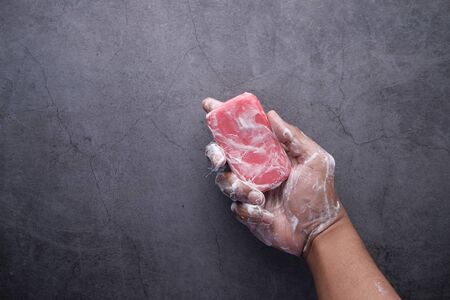 young man washing hand with soap, Top viewの写真素材