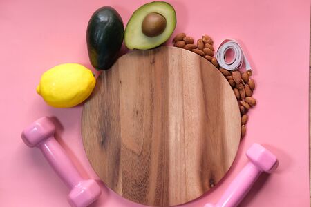 diet plan concept with chopping board and healthy fruits on pink backgroundの写真素材