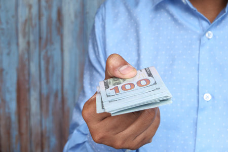 Close up of hand holding us dollar with copy space
