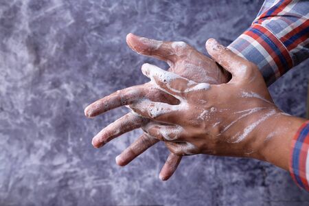 young man washing hand with soap, Top viewの写真素材