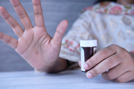 Close up of women holding pill containerの写真素材