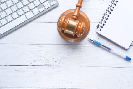 Top view of gavel, notepad and keyboard on tableの写真素材
