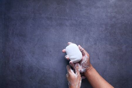 young man washing hand with soap, Top viewの写真素材