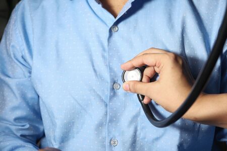 Doctor using a stethoscope checking body, close upの写真素材