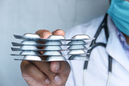 Close up of doctor hand holding blister packの写真素材