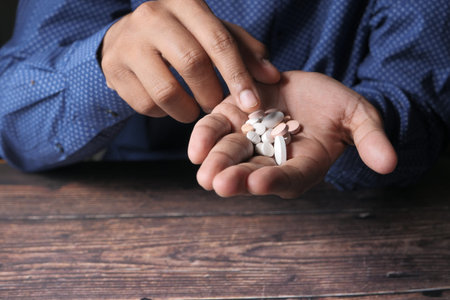 young man taking medicine, Close up
