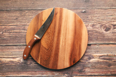 Top view of wooden chopping board on gray background .の写真素材