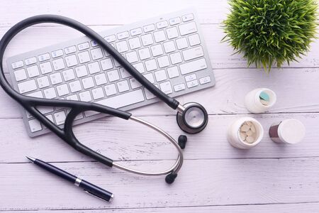 Medical Stethoscope and keyboard on black backgroundの写真素材