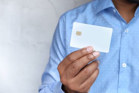 Man in casual dress showing credit cardの写真素材