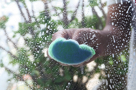 Close up of man hand cleaning window glassの写真素材