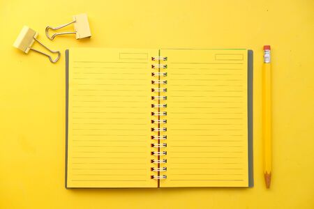 high angle view of yellow color notepad yellow deskの写真素材