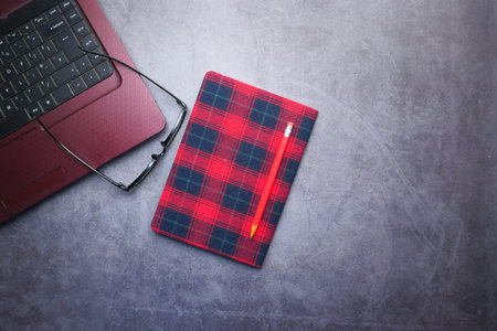 high angle view of laptop and notepad on table