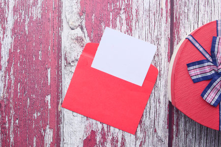 heart shape gift box and envelope on table