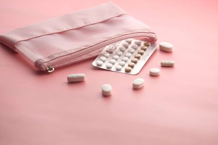 birth control pills on pink background with copy spaceの写真素材