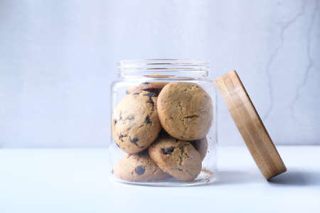 Jar full of chocolate chip cookies on white backgroundの写真素材
