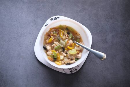chicken vegetable soup on a black backgroundの写真素材