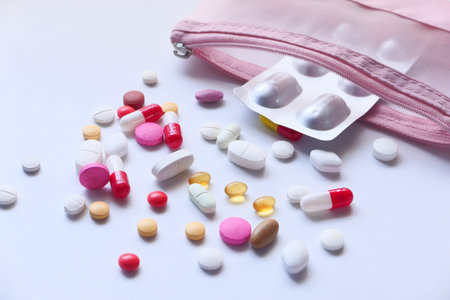 colorful pills spilling on white background, close up