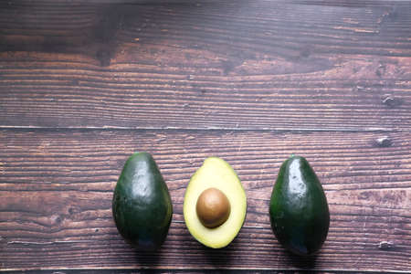 close up of slice of avocado on wooden tableの写真素材