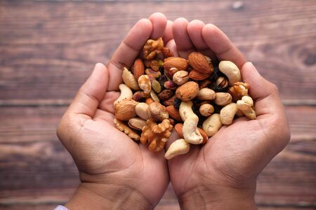 mixed nut on palm of hand top downの写真素材